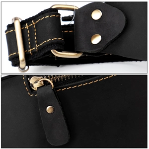 Detail of vintage black crazy horse leather waist bag with brass hardware and yellow stitching