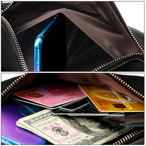 Detailed internal view of black leather waist bag with multiple card slots and phone pocket