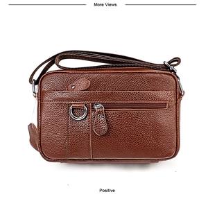 Macro detail of brown litchi pattern leather messenger bag with multi-zipper pockets