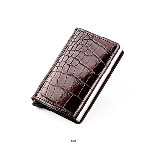 Detail view of the pop-up aluminum credit card holder with brown crocodile pattern