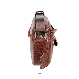 Side view of dark brown lychee textured leather crossbody bag with nylon strap