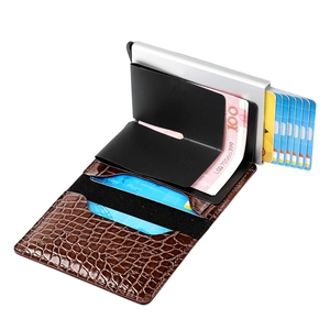 Macro detail of brown crocodile texture wallet with silver aluminum card ejector case