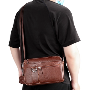 Detailed back view of a brown genuine leather crossbody bag worn by a male model