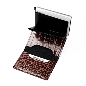 Detail of brown crocodile textured leather wallet with aluminum pop-up card mechanism