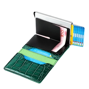 Detail view of RFID blocking pop-up credit card wallet with green crocodile texture
