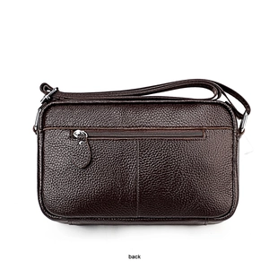 Detailed back view of dark brown pebbled leather bag with a secure metal zipper pocket