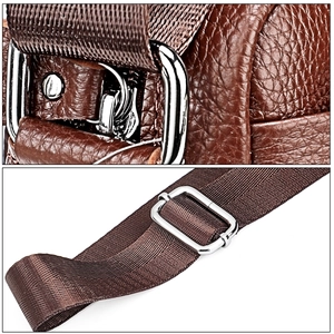Detail of brown litchi grain leather bag with adjustable strap and metal hardware