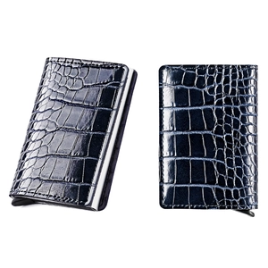 Detail view of crocodile pattern aluminum card holder with automatic pop-up mechanism