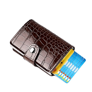 Detailed close-up of dark brown crocodile texture wallet with pop-up aluminum card holder