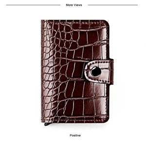 Detail of dark brown crocodile leather card wallet with metallic silver snap fastener