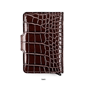 Detail view of the back of a dark brown crocodile leather pop-up wallet with stitching