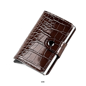 Side view of dark brown crocodile pattern pop-up card holder with metal buckle