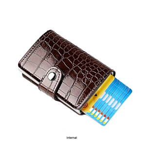 Detail view of the brown crocodile pattern wallet with metallic pop-up card case