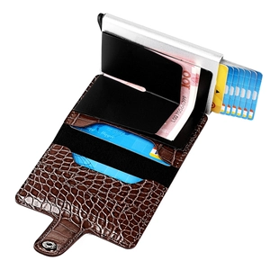Detailed view of brown crocodile leather RFID wallet showing card ejection and cash storage