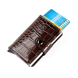 Detail of dark brown crocodile pattern wallet with silver buckle and pop-up aluminum card holder