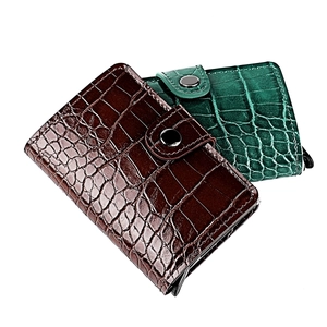 Detail of crocodile texture leather card holders with automatic pop-up aluminum mechanism