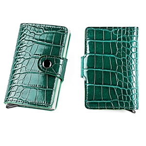 Detailed view of dark green crocodile texture card holder with metal automatic pop-up case