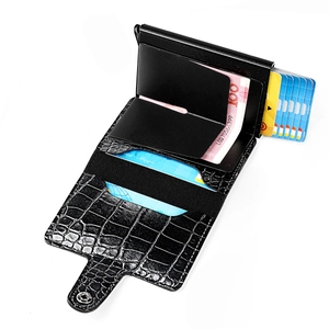 Detail view of crocodile-patterned leather wallet with automatic pop-up aluminum card holder