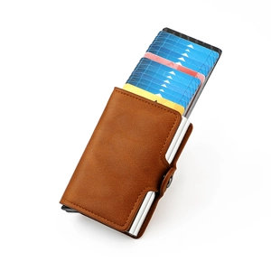 Detail of RFID blocking brown leather card holder with automatic pop-up aluminum wallet mechanism