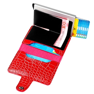 Detail view of red crocodile leather card wallet showing pop-up metal card box and slots