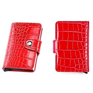Detailed close-up of red crocodile pattern card holder with silver metal buckle closure