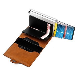 Detail view of RFID blocking pop-up card wallet with brown leather shell and coin compartment