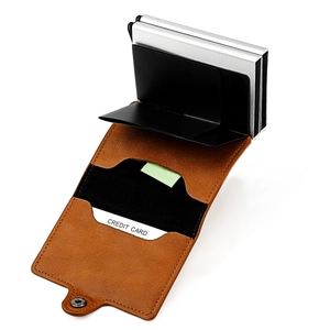 Detail of RFID pop-up card holder with silver aluminum case and brown leather strap