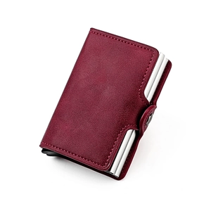 Detail of burgundy leather RFID blocking card holder with buckle and automatic pop-up mechanism