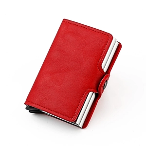 Detail of red leather RFID wallet with dual aluminum card pop-up mechanism and snap closure