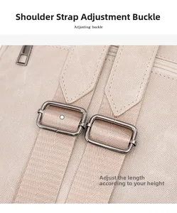 Close-up of adjustable metal buckle and woven shoulder straps on a beige travel backpack