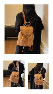 Detail of brown matte backpack with drawstring closure and vintage metal buckle hook