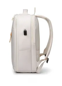 Side view of beige backpack showing USB charging port and breathable mesh back padding