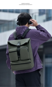 Detail of army green outdoor backpack with multi-pocket design on a male model back