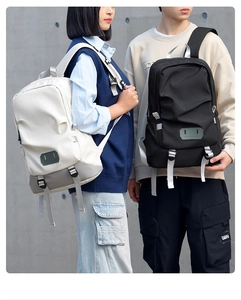 Detail of waterproof travel backpacks in beige and black with durable buckles and straps