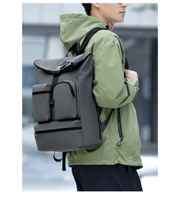 Detail of dark grey water-resistant backpack with multiple zip pockets in outdoor city use