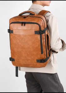 Brown PU leather travel backpack featuring multi-layer compartments and breathable back pad
