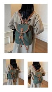 Detail view of retro green backpack with brown leather straps and drawstring closure