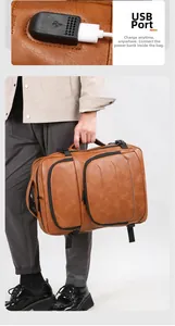 Detail view of the external USB charging port on a brown leather business travel backpack