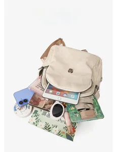 Overhead shot of multi-compartment canvas bag showing large capacity for tablets and books