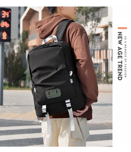 Macro detail of black travel backpack featuring adjustable straps and 'Believe in yourself' text