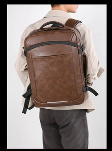 Brown vintage style faux leather business backpack shown on model with adjustable straps
