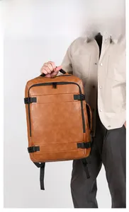 Detail of tan faux leather backpack featuring black zippers and side buckle closure