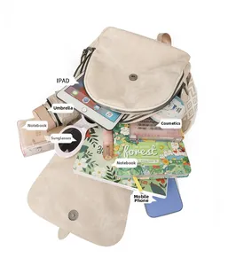 Detailed interior of beige corduroy backpack showing large capacity for laptop and daily items