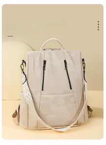 Detail of beige multi-way backpack with jacquard shoulder strap and zip pockets