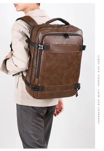 Close-up of brown PU leather business backpack with ergonomic straps and top handle