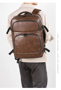 Close-up of vintage brown PU leather business backpack with safety reflective strip on bottom