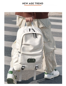 Close-up of cream canvas backpack featuring Believe in yourself label on street background