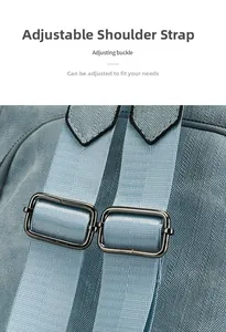 Detail of adjustable shoulder strap with sturdy metal buckle on gray blue backpack