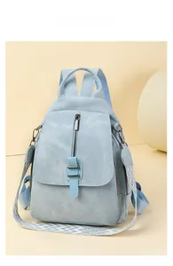 Detail of light blue denim textured backpack with metal zippers and woven jacquard straps