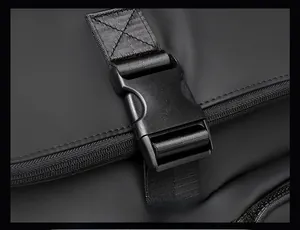 Detail of waterproof matte black backpack featuring secure plastic buckle and sturdy zipper
